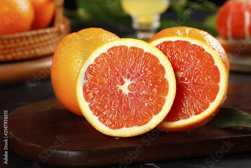Fresh Cut Navel Oranges with Red Flesh on Wooden Board - Healthy Citrus Fruit Food Photography