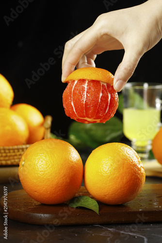Fresh Chinese Blood Orange from Gannan Jiangxi Being Peeled Showing Red Pulp and Juice