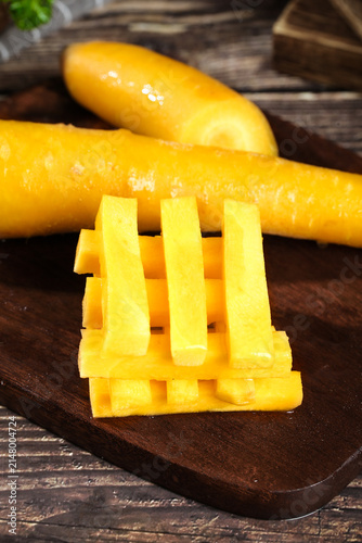Fresh Yellow Xinjiang Carrots on Wooden Board - Seasonal Farm Produce