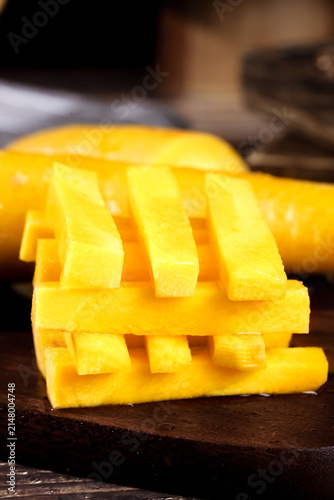 Fresh Yellow Xinjiang Carrots Cut in Decorative Lattice Pattern on Wooden Board