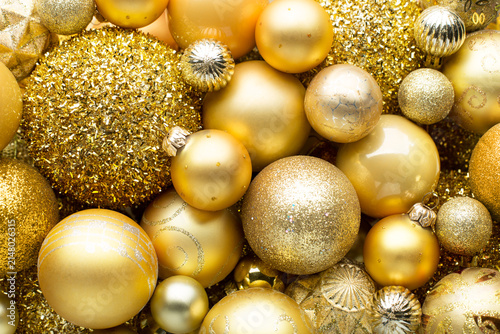 Monochrome  backgraund  of  golden Christmas  ornaments different sizes, shades and textures. Flay lay