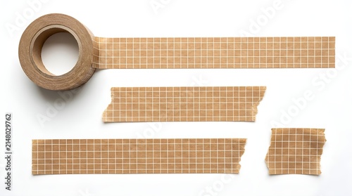 Kraft paper grid masking tape roll and adhesive torn tape strips isolated on white background