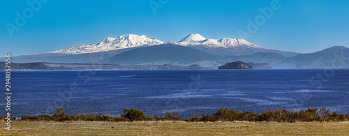 Lake Taupō, New Zealand, snowy volcanoes Mt Ruapehu, Ngauruhoe and Tongariro. Mt Pihanga, Tūrangi town, Motutaiko Island. Panoramic view.