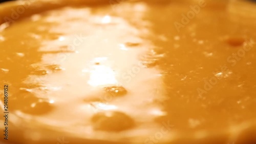 Close up of golden caramel sauce smooth texture food photography