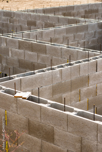 Vertical view of a house foundation grid made of grey concrete blocks