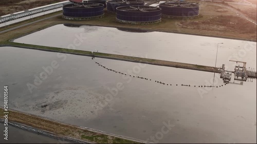 Wastewater treatment facility with basin infrastructure, water management, environmental engineering and sustainability, aerial view.