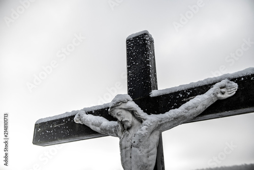 Jesus on the cross covered with a fresh layer of snow