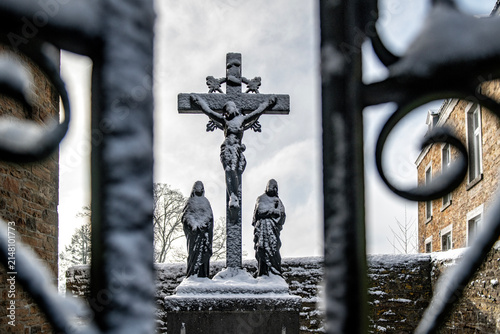 Canvas Print Jesus on the cross covered with a fresh layer of snow