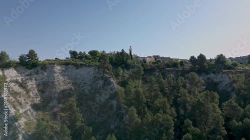 Benillup village sitting on a hill with a prominent church tower, overlooking surrounding green trees and the distant Spanish mountains of Costa Blanca - stock video