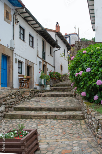 Beautiful street with traditional houses at Tazones, Asturias, Spain