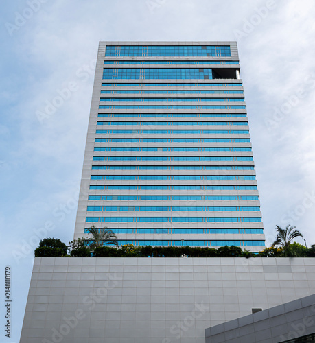 Bottom up view modern office building on blue sky background