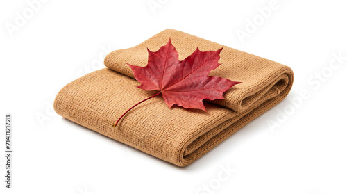 Folded beige knitted scarf with a red maple leaf isolated on white background