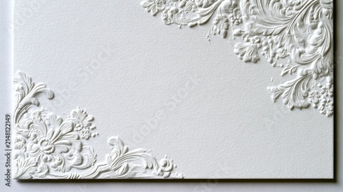 White embossed floral border on textured paper