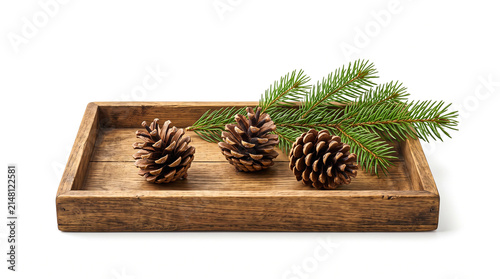 Three pinecones and a fir branch on a wooden tray isolated on white background