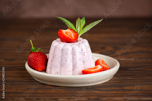 Healthy strawberry chia pudding made with cottage cheese and decorated with mint leaves and berries, homemade protein dessert.