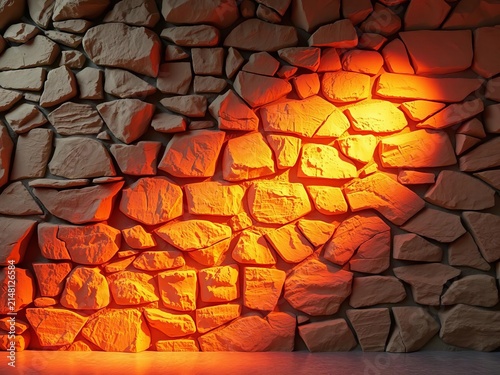 Rocky textured stone wall glows warmly in spotlight, backdrop, tile
