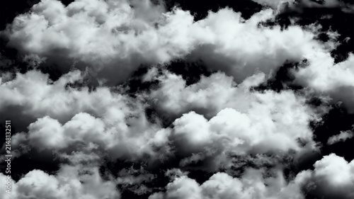 Canvas Print Fluffy white clouds against a dark black sky in the atmosphere