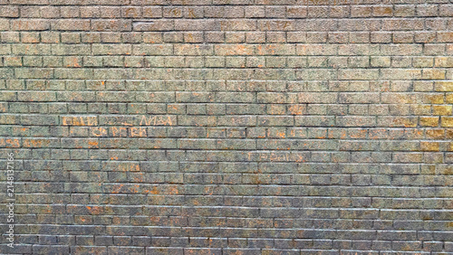 Old brick wall with signs of wear and history in a city setting