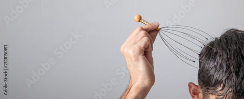 Fotografía Man massaging head with a massager tool.