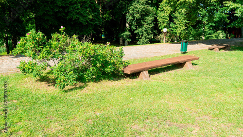 Fotografie Wooden bench and shrub in park during daytime The Augustow Canal on the Vistula River and the Neman River in Belarus Grodno Region on July 25, 2026