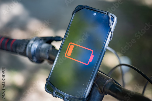 Low battery: A smartphone on a bicycle handlebar shows power outages and communication disruptions during a conflict.