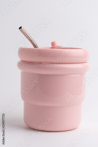 Pink reusable insulated stainless steel cup with metal straw on white background