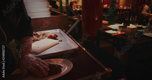 Chef Preparing to Serve roast Peking Duck in a Restaurant Setting