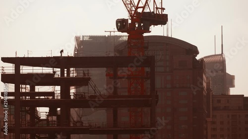 Shanghai, China. Time-lapse Urban Skyline with construction site works. crane working development. City Business Center. Smog at morning, smog in big city