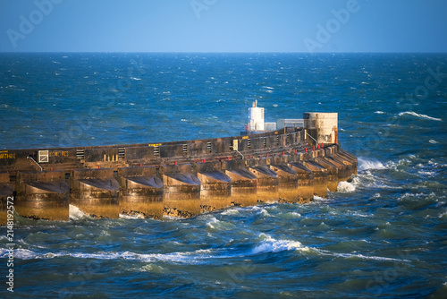Фотография Storm Waves Crashing Against Concrete Breakwater