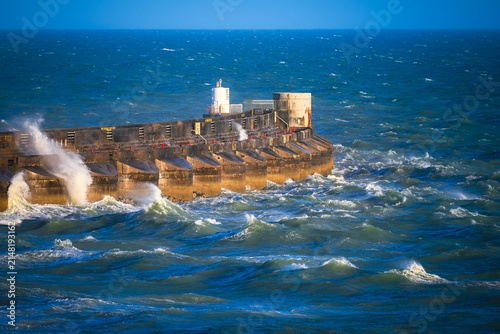 Фотография Storm Waves Crashing Against Concrete Breakwater
