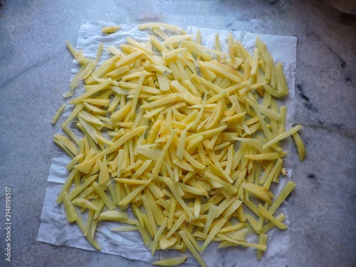 Bild auf Leinwand freshly cut potato sticks drying on a paper towel, a crucial step for achieving