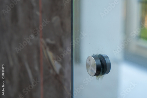 Konstfotografi Close up of a stainless steel glass standoff pin holder installed on a panel