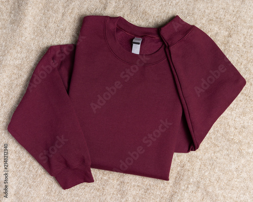 Blank dark red unisex sweatshirt mockup, folded apparel template, copy space on front and sleeves