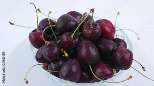 Top view ripe cherry clustered inside glass bowl against white background, sweet fruit composition supports healthy eating campaigns, premium produce, seasonal harvest for branding projects. 4k 