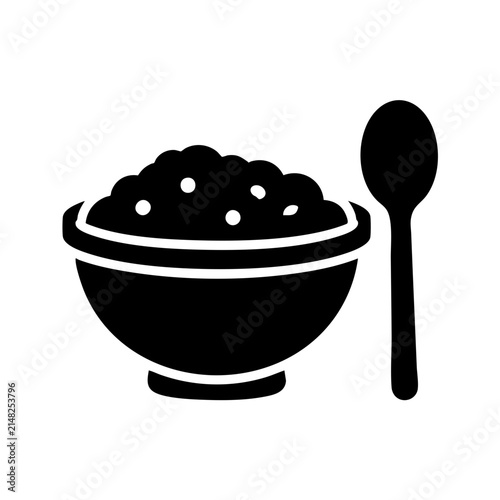 Black bowl of porridge with a matching spoon