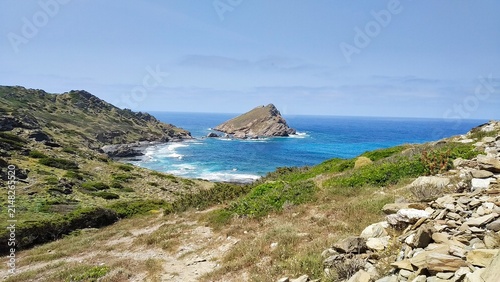 A rocky coastal landscape overlooking the island of Porri near Stintino in Sardinia (Italy).