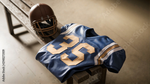 Football jersey and helmet placed on wooden bench in locker room  