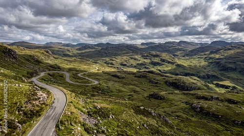 Winding road through the dramatic, rugged landscape of the highlands under a cloudy sky