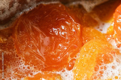 Cooking apricot confiture with foam.  Apricots jam making process. Apricot Jam. Shallow depth of field.