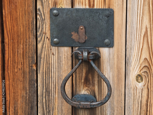 Antique wrought iron door knocker for wooden door