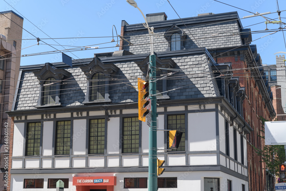 Fototapeta premium historic building facade and sign of The Carbon Snack Bar, a restaurant, located at 460 King St W, Toronto