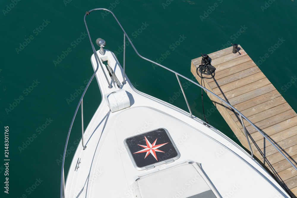 Fototapeta premium top-down detail of a boat with a nautical star patch and floating dock, Toronto