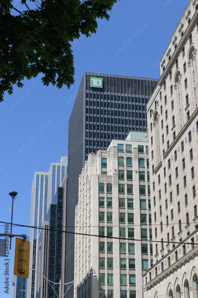 Fototapeta premium looking north on York St to buildings on the east side including TD Centre and corporate logo and Fairmont Royal York hotel, Toronto