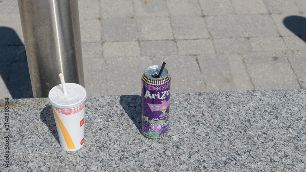 Fototapeta premium discarded beverage cup from McDonald's Canada and aluminum can of AriZona Grapeade, Toronto