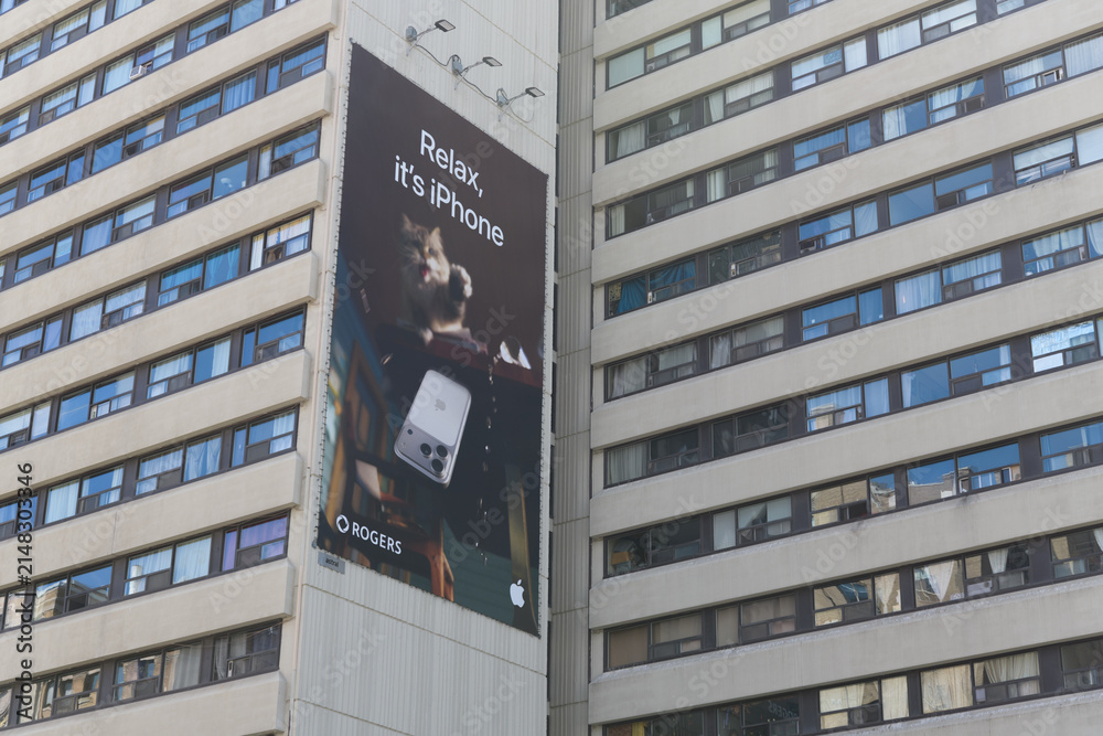 Fototapeta premium Apple Inc wall banner advertisement outside Senator David A Croll Apartments, 341 Bloor St W, Toronto