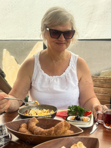 Woman Enjoying Turkish Breakfast at Outdoor Cafe