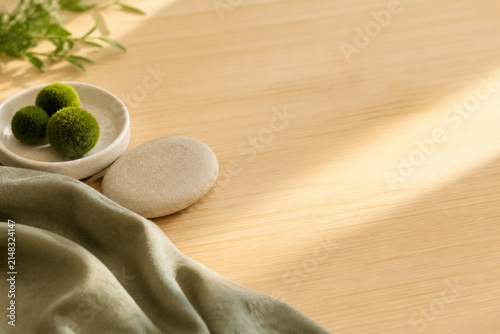 Obraz na plátně Stone dividing moss spheres and sage linen on desk, nature therapy and healthcar