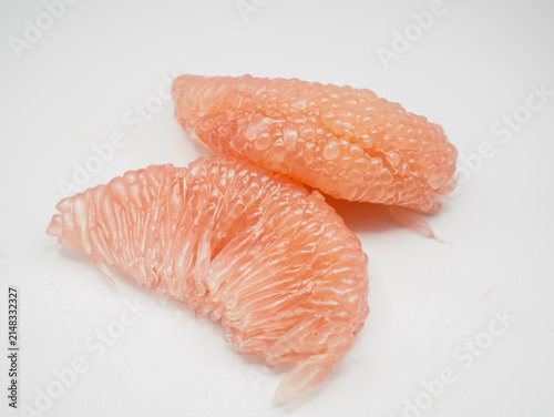 Freshly peeled pink grapefruit segments highlighting natural juicy texture and pink color