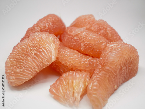 Detailed macro view of sweet and juicy red pomelo citrus pulp segments
