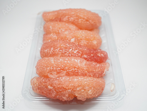 A pile of juicy red pomelo pulp segments showcasing rich texture and natural pink color.